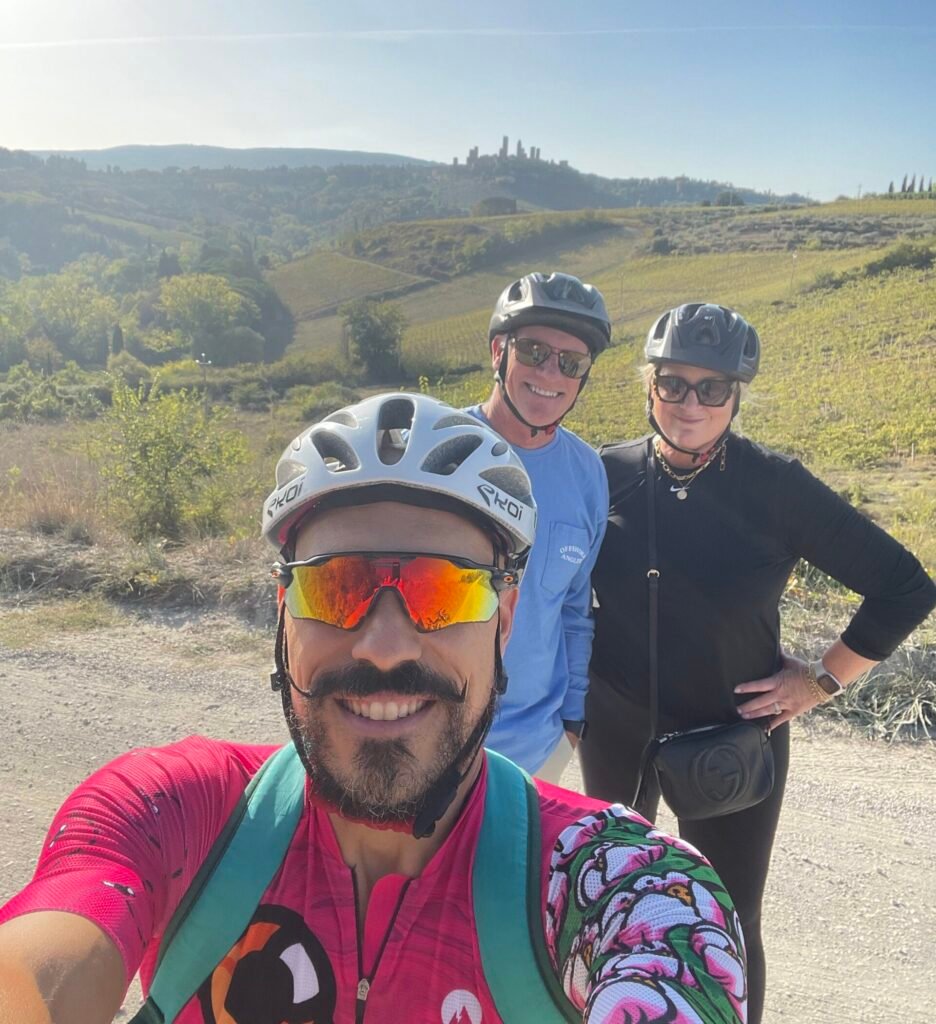Private guide with smiling clients on private bike tours in San Gimignano